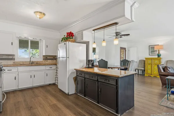 a kitchen with sink cabinets and refrigerator