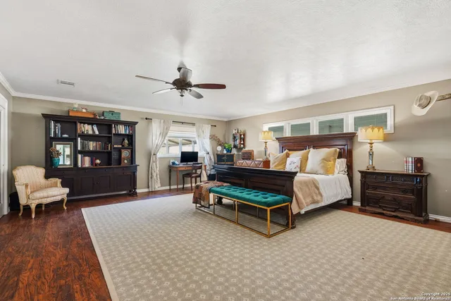 a spacious bedroom with a large bed and a tv