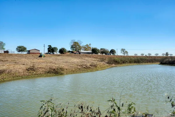 a view of a lake with houses in the back