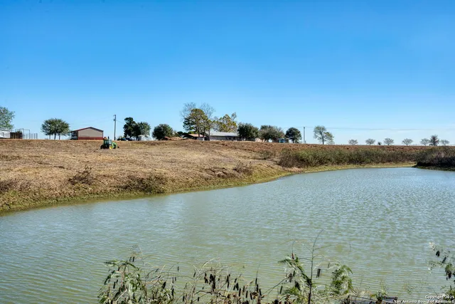 a view of a lake with houses in the back