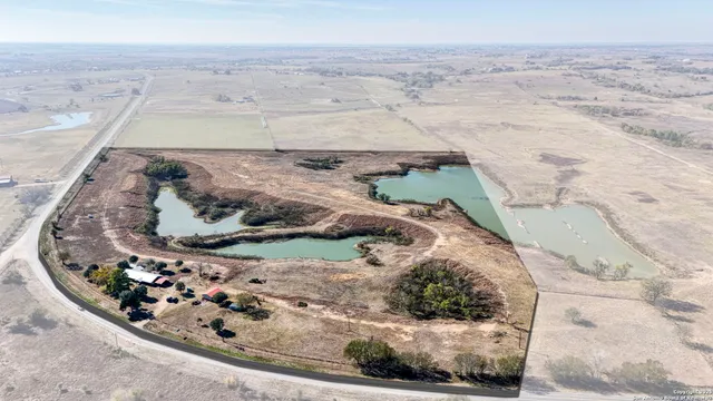 an aerial view of a houses with ocean view