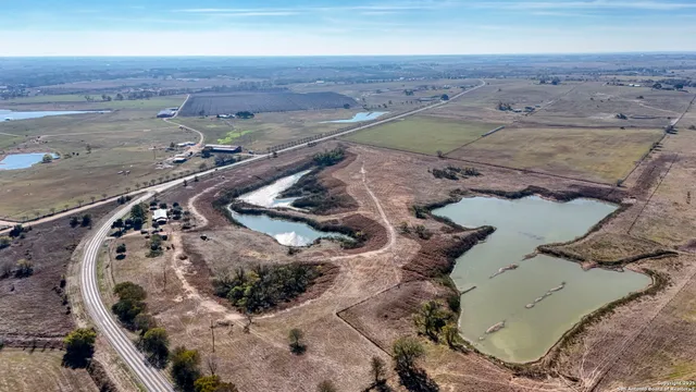 an aerial view of a house with a lake view
