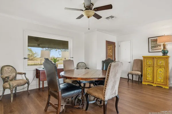 a view of a dining room with furniture window and wooden floor