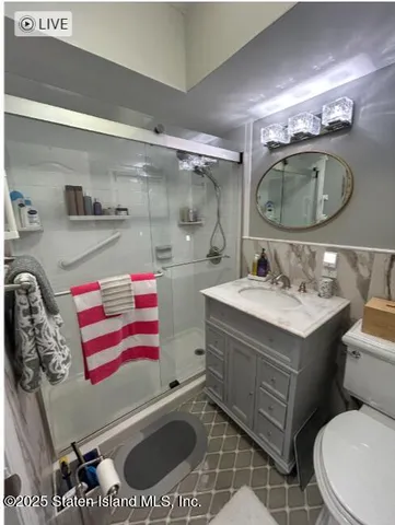 a bathroom with a sink mirror vanity and toilet