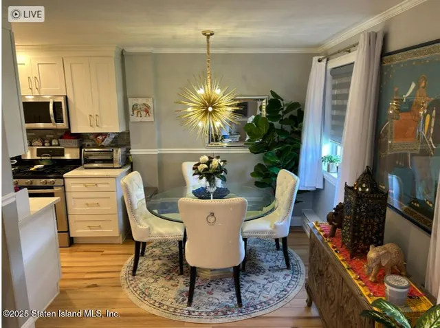 a dining room with furniture a chandelier and window