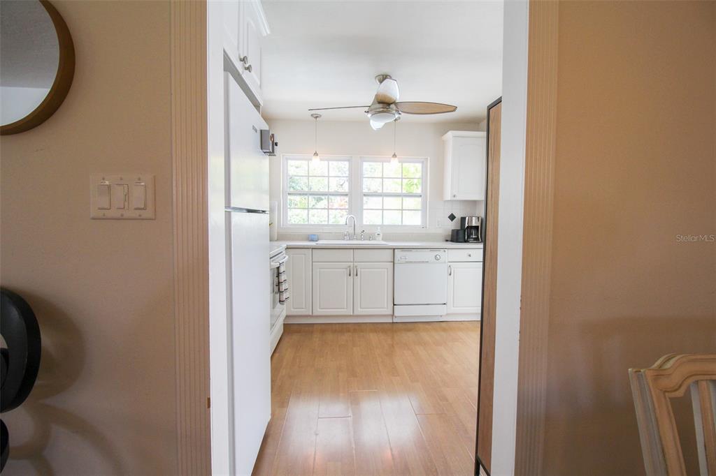 3223 Rowena Street Sarasota, FL 34231 - Photo 14 of 51 a view of a kitchen with wooden floor and a window