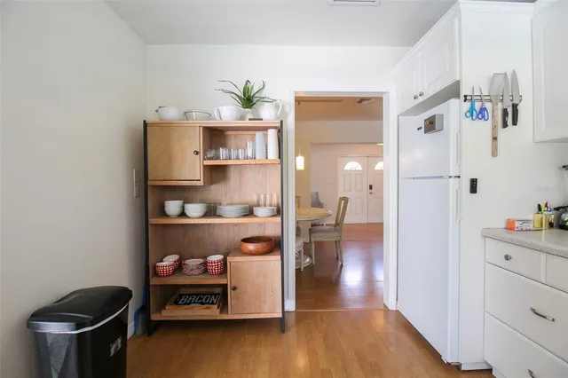 a view of workspace with wooden floor and cabinet