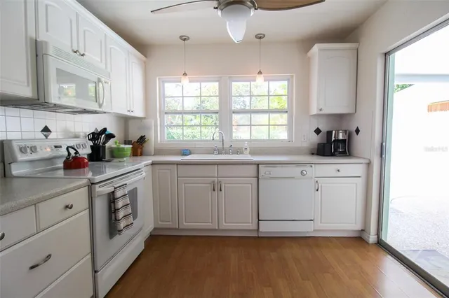 a kitchen with a sink cabinets and window