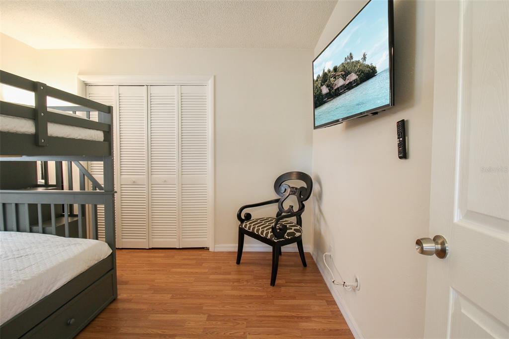 3223 Rowena Street Sarasota, FL 34231 - Photo 22 of 51 a bedroom with a bed and a table