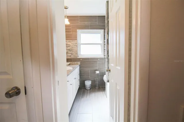 a bathroom with a granite countertop toilet and a shower