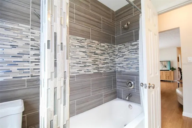 a bathroom with a bathtub and a shower