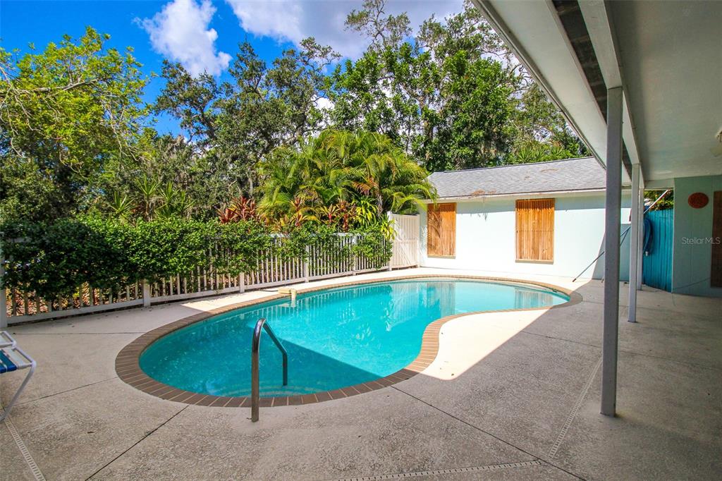 3223 Rowena Street Sarasota, FL 34231 - Photo 28 of 51 a view of a swimming pool with a patio