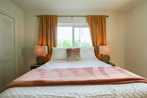 a bedroom with a bed and window