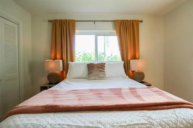 a bedroom with a bed and window