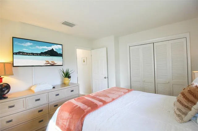 a bedroom with a bed and cabinet