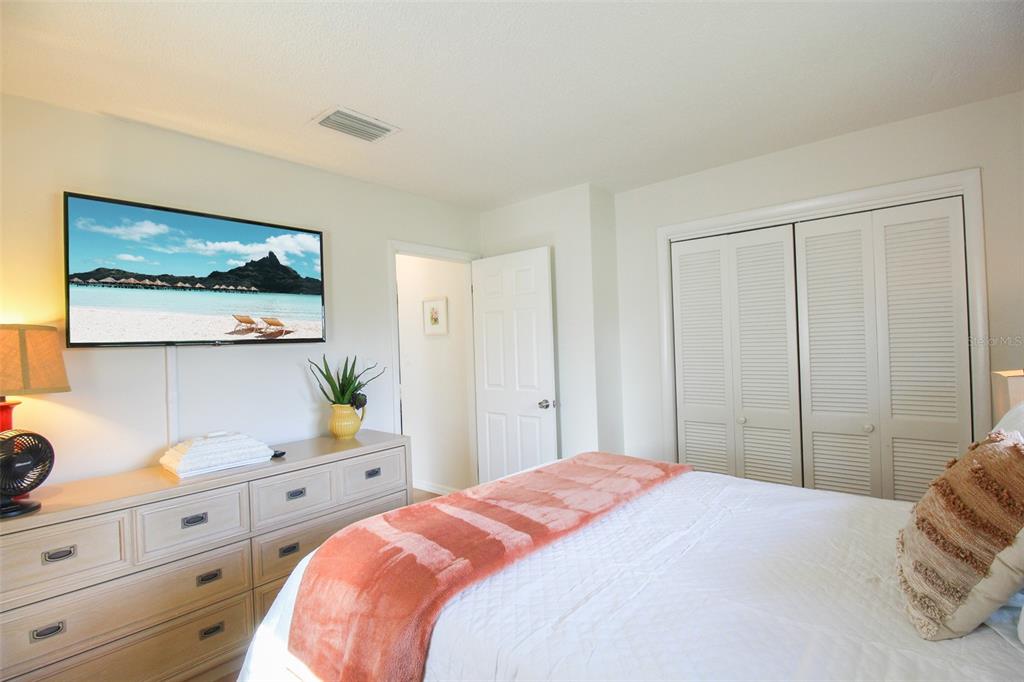 3223 Rowena Street Sarasota, FL 34231 - Photo 30 of 51 a bedroom with a bed and cabinet