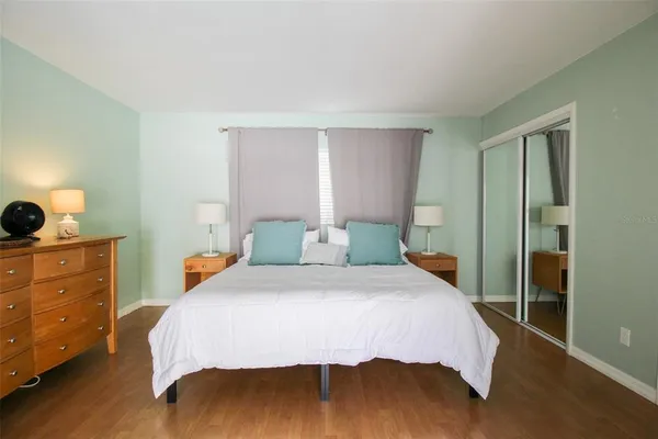 a bedroom with a bed and a dresser