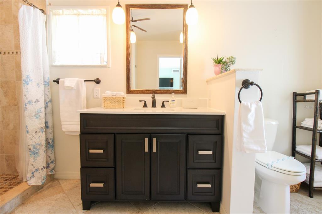 3223 Rowena Street Sarasota, FL 34231 - Photo 37 of 51 a bathroom with a sink vanity mirror and toilet