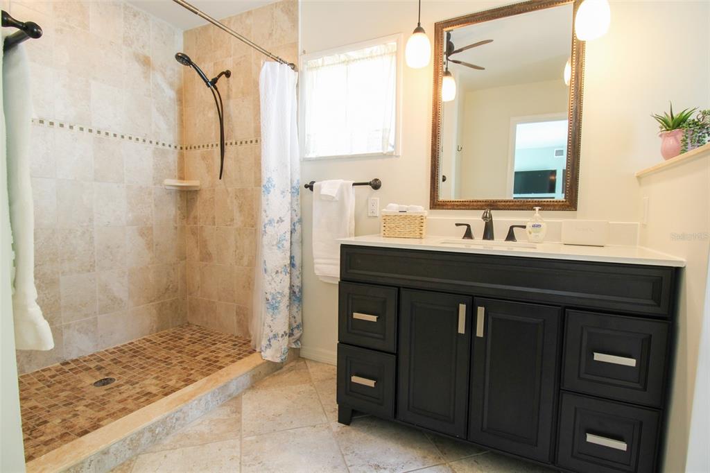 3223 Rowena Street Sarasota, FL 34231 - Photo 38 of 51 a bathroom with a sink and a mirror