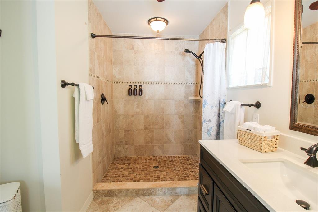 3223 Rowena Street Sarasota, FL 34231 - Photo 40 of 51 a bathroom with a sink shower and a mirror