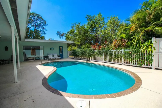 a view of a house with swimming pool and porch