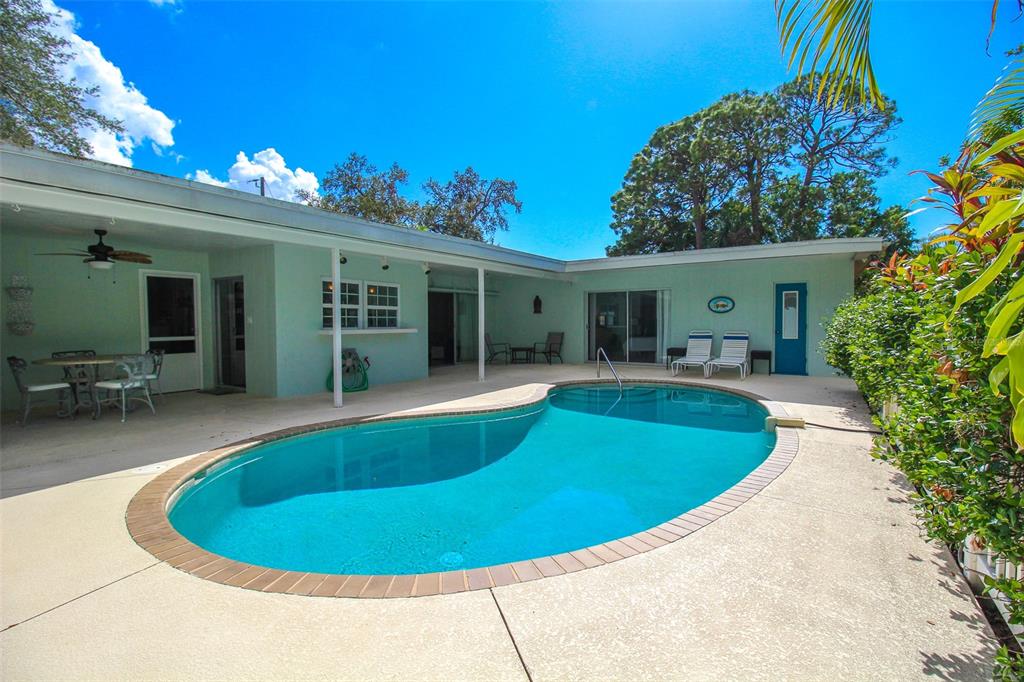 3223 Rowena Street Sarasota, FL 34231 - Photo 45 of 51 a view of a house with swimming pool and porch