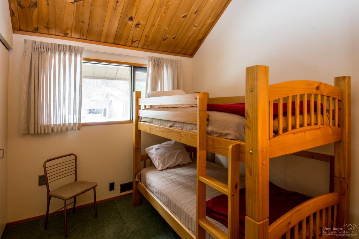 13 Ranch Cabin Road Sunriver, OR 97707 - Photo 11 of 21 a bedroom with a bunk bed and a window