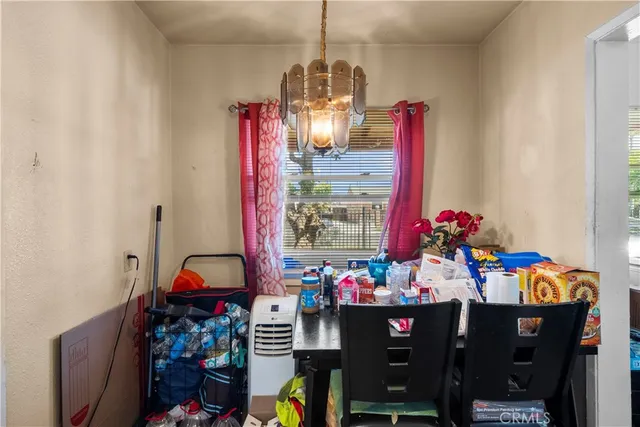 a view of a dining room with furniture and chandelier