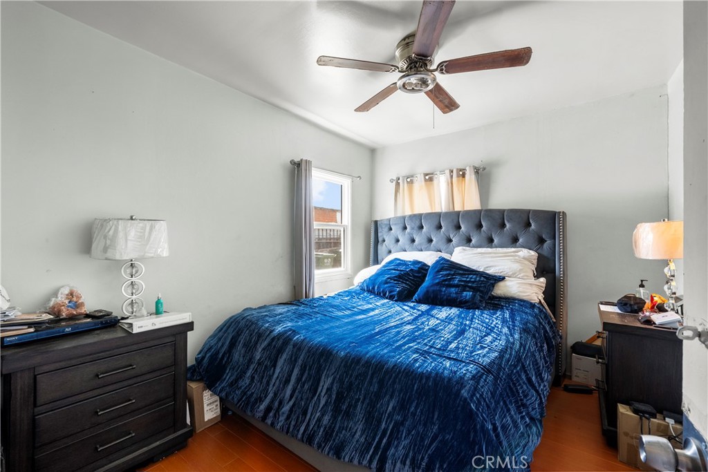 908 West 132nd Street Compton, CA 90222 - Photo 16 of 36 a bedroom with a bed and a chandelier