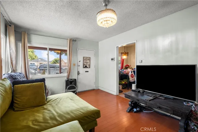 a bedroom with furniture and a flat screen tv