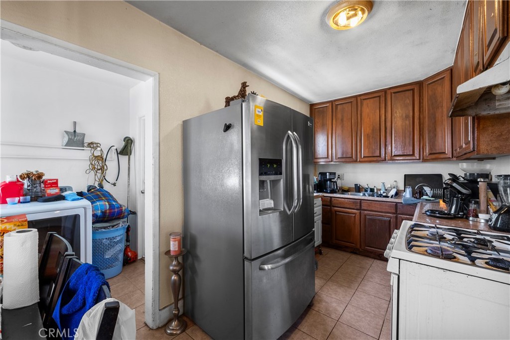 908 West 132nd Street Compton, CA 90222 - Photo 8 of 36 a kitchen with a refrigerator and a stove top oven