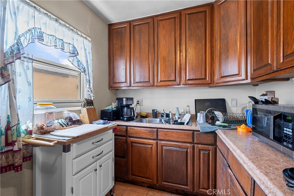 908 West 132nd Street Compton, CA 90222 - Photo 10 of 36 a kitchen with stainless steel appliances granite countertop a sink stove and cabinets