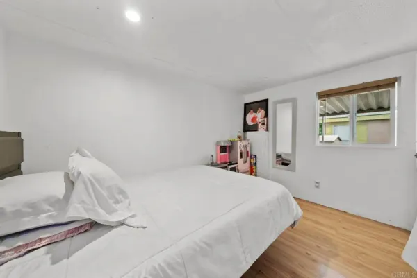 a bedroom with a bed and a window