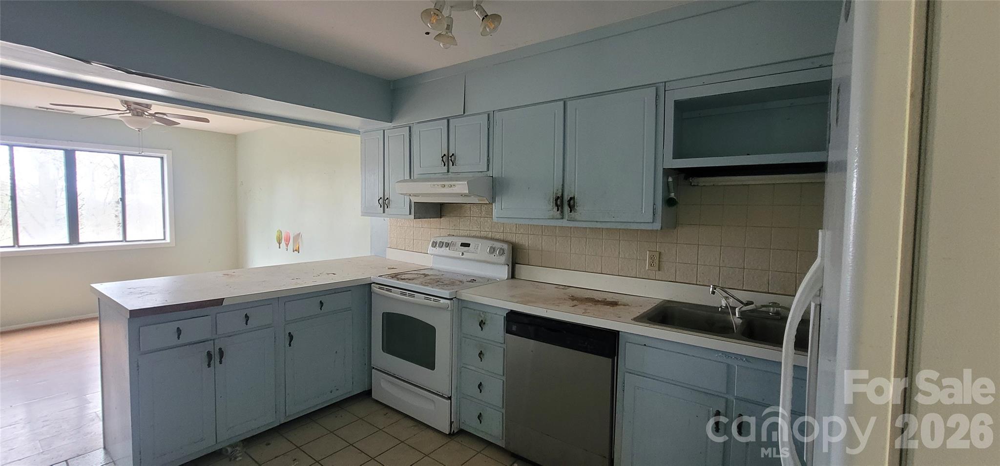 7882 Kinglet Road Connelly Springs, NC 28612 - Photo 11 of 40 a kitchen with a sink stove and cabinets