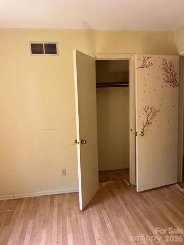 a view of room with window and hardwood floor