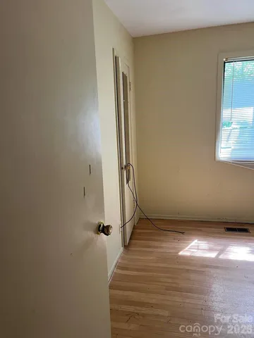 a view of a hallway with wooden floor and a hallway