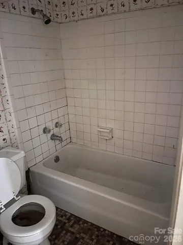 a bathroom with a shower and a mirror