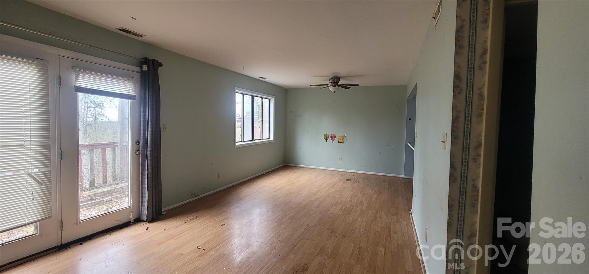 7882 Kinglet Road Connelly Springs, NC 28612 - Photo 9 of 40 a view of an empty room with wooden floor and a window