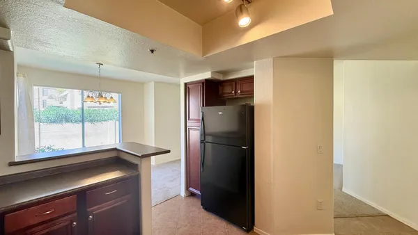 a kitchen with a refrigerator and a window