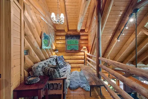 a living room with furniture and a chandelier