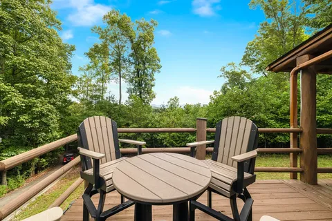 a view of a chairs and table in the balcony
