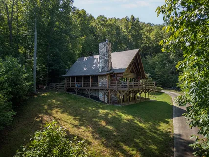 a view of a house with garden and a trees