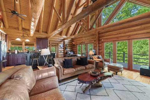 a living room with furniture a ceiling fan and a window