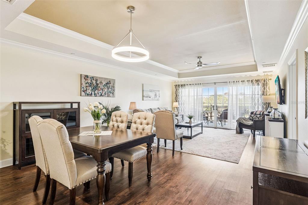 1356 Centre Ct Ridge Drive, Unit 202 Reunion, FL 34747 - Photo 11 of 67 a view of a dining room and livingroom with furniture wooden floor a chandelier