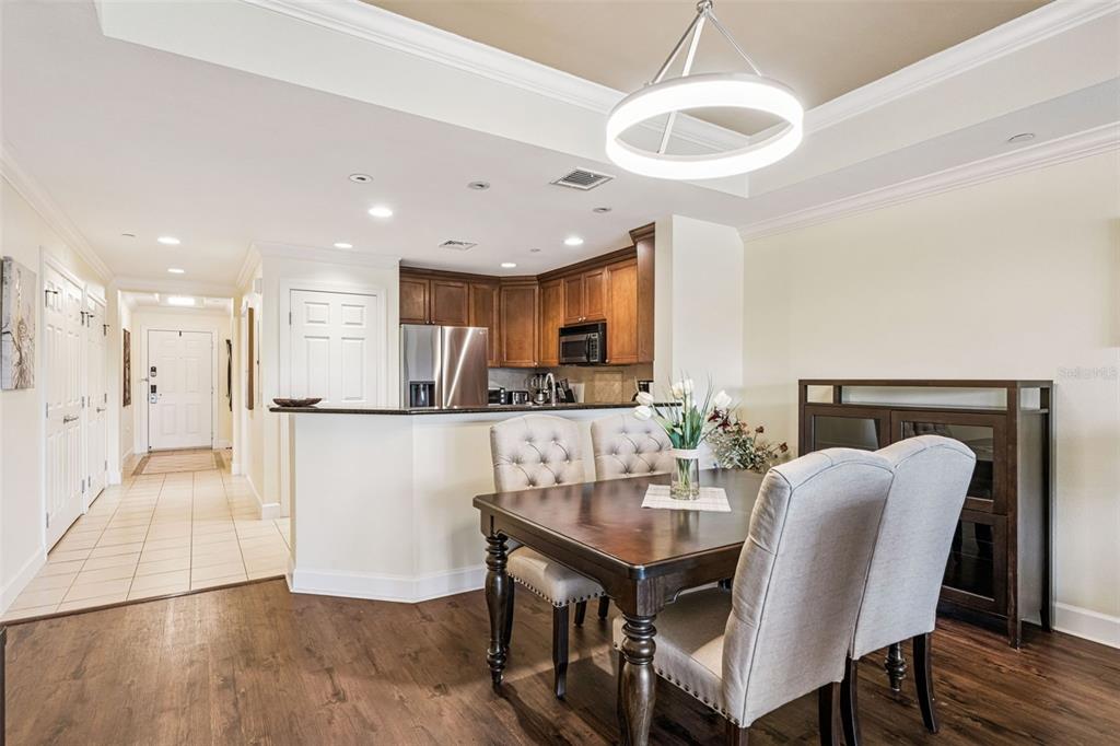 1356 Centre Ct Ridge Drive, Unit 202 Reunion, FL 34747 - Photo 13 of 67 a kitchen with stainless steel appliances granite countertop a table chairs and a refrigerator