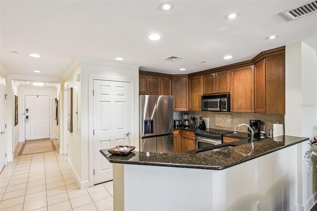 1356 Centre Ct Ridge Drive, Unit 202 Reunion, FL 34747 - Photo 15 of 67 a kitchen with stainless steel appliances granite countertop a sink a stove and a refrigerator
