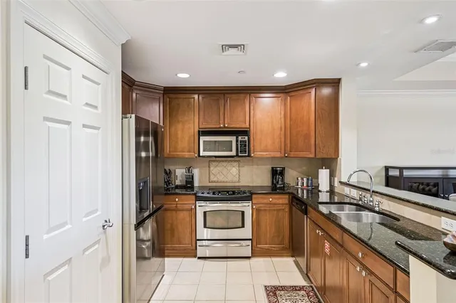 a spacious bedroom with a bed and a flat screen tv