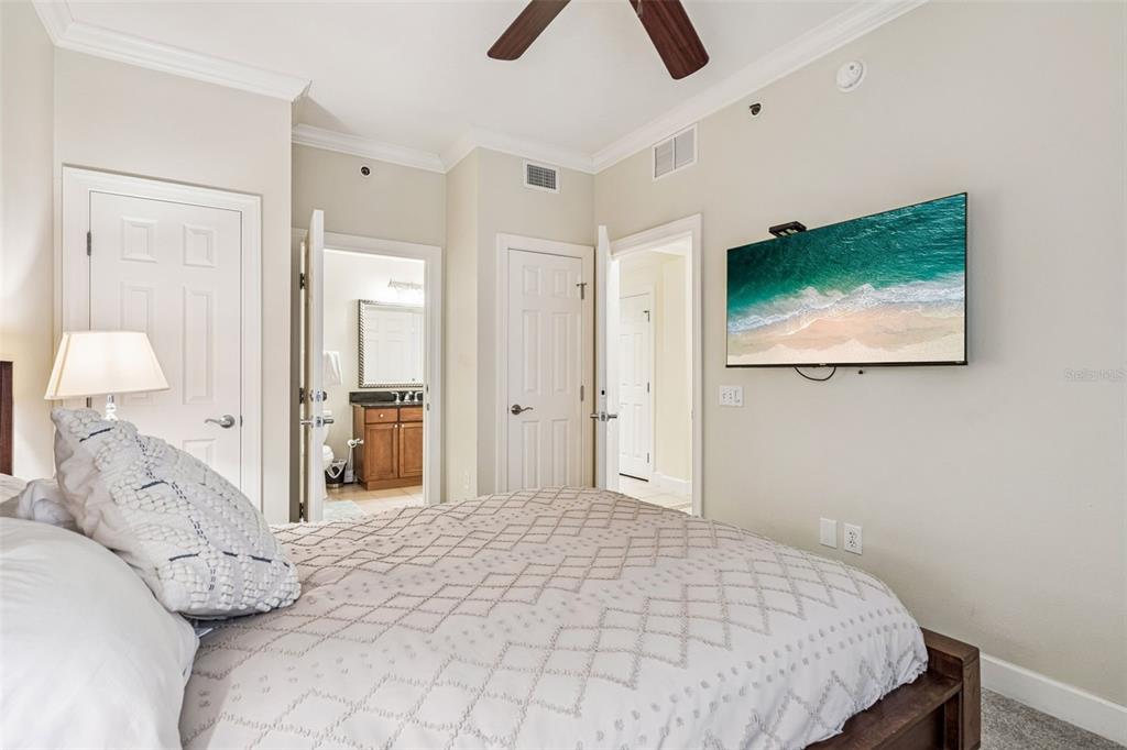 1356 Centre Ct Ridge Drive, Unit 202 Reunion, FL 34747 - Photo 22 of 67 a spacious bedroom with a bed and a flat screen tv