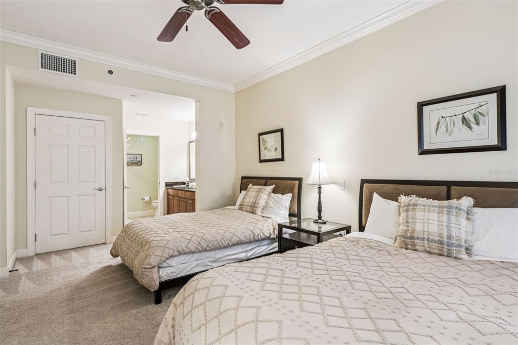 1356 Centre Ct Ridge Drive, Unit 202 Reunion, FL 34747 - Photo 24 of 67 a bedroom with two beds and painting on the wall