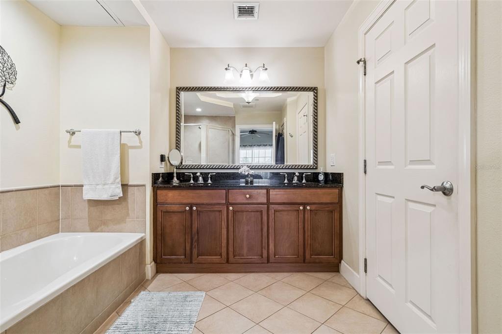 1356 Centre Ct Ridge Drive, Unit 202 Reunion, FL 34747 - Photo 26 of 67 a spacious bathroom with a mirror a sink and a bathtub